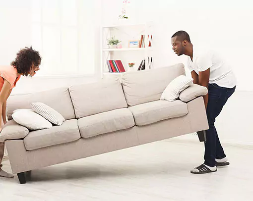 tile | Select Floors two people moving couch | Select Floors