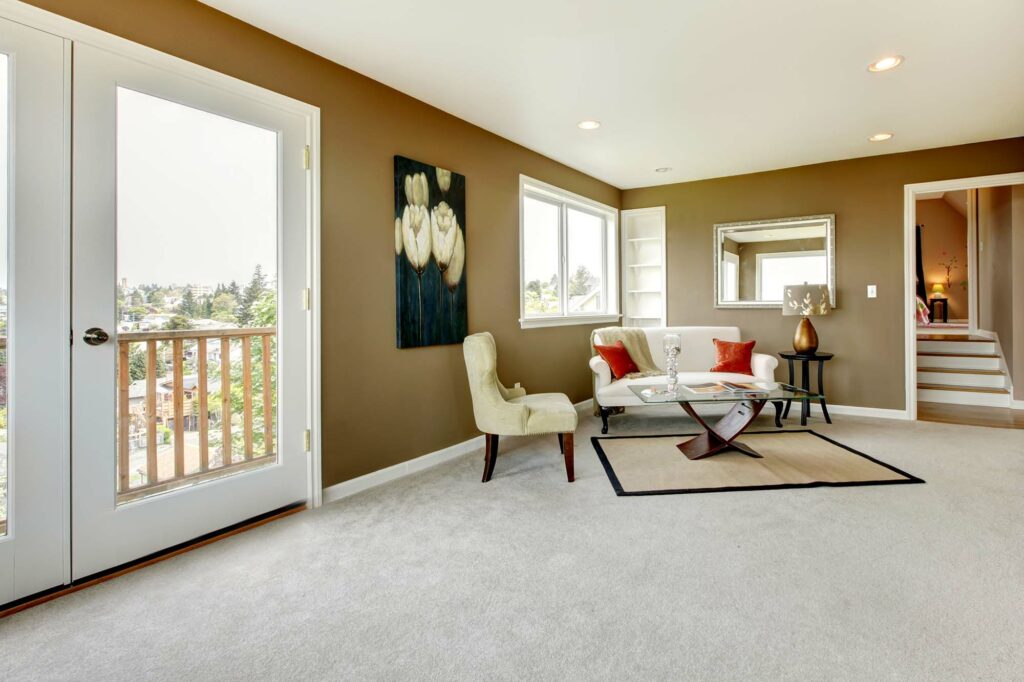 Carpet in a living room with a couch and chair by Select Floors in Marietta, GA | Select Floors