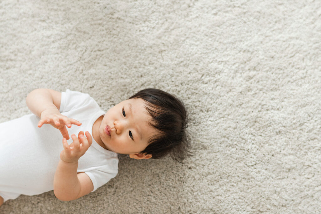 Comfortable Carpet with a baby laying on the carpet floors by Select Floors in Marietta, GA