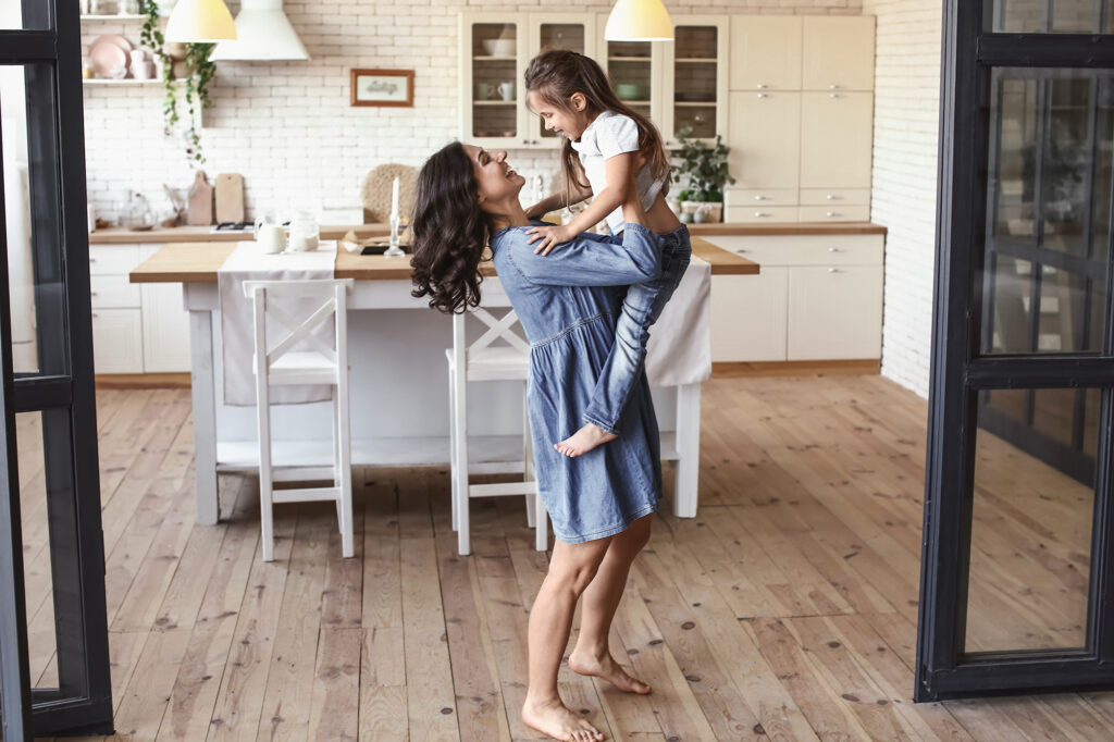 hardwood flooring in dining area with mother and daughter | Select Floors