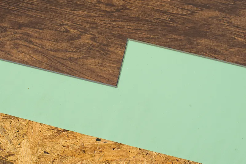 Vinyl-Subflooring Subfloor with partially completed foam backing and vinyl plank flooring installation