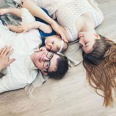 family laying on laminate flooring | Select Floors